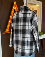 Back view of black and white plaid shacket showing relaxed fit and soft texture