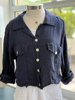Navy linen jacket layered over basic white tank