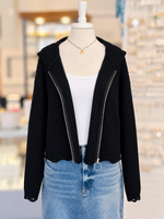 Kennedy Hoodie in black featuring textured open knit, a full zipper with ring pull, hood, and cropped distressed hem, styled with denim at Ardor Boutique.