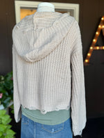 Back view of the Kennedy Hoodie in sandy beige featuring a soft textured knit, relaxed cropped fit, long sleeves, and knit hood at Ardor Boutique.