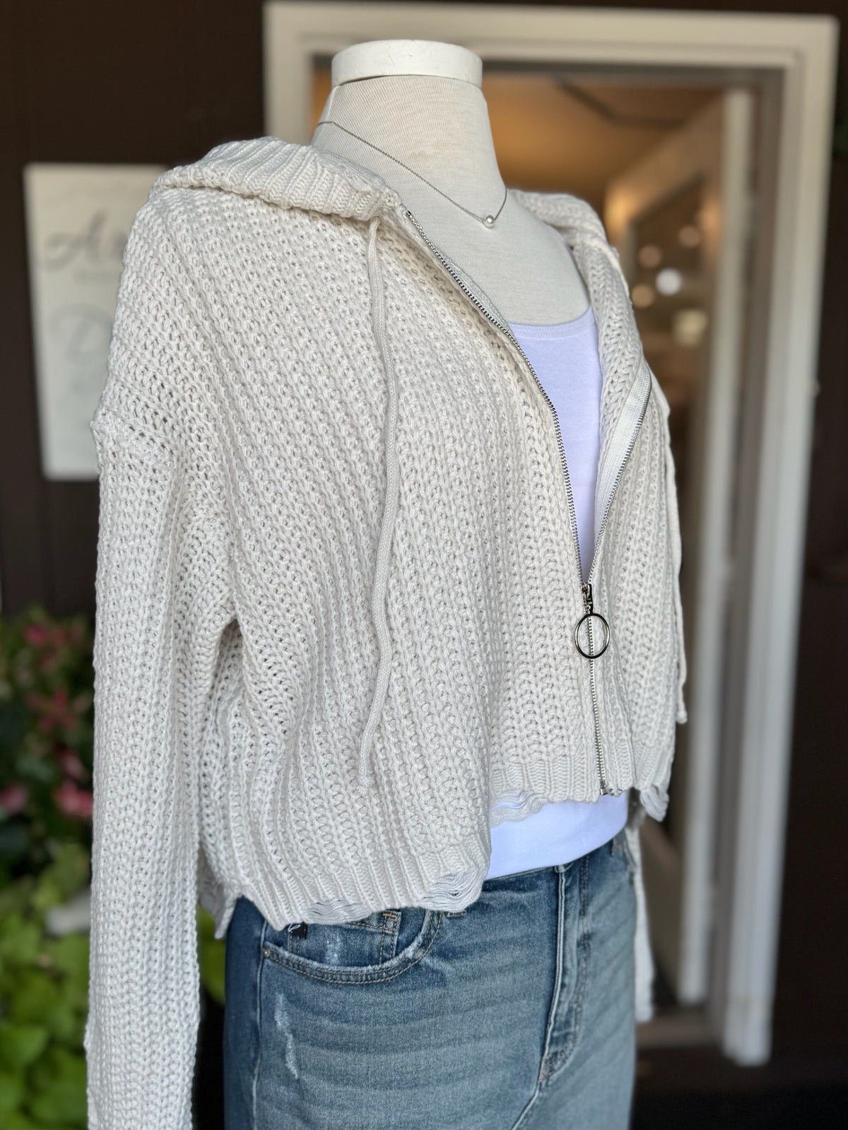 Kennedy Hoodie in Ivory side view on mannequin. Shows hoodie zipped up