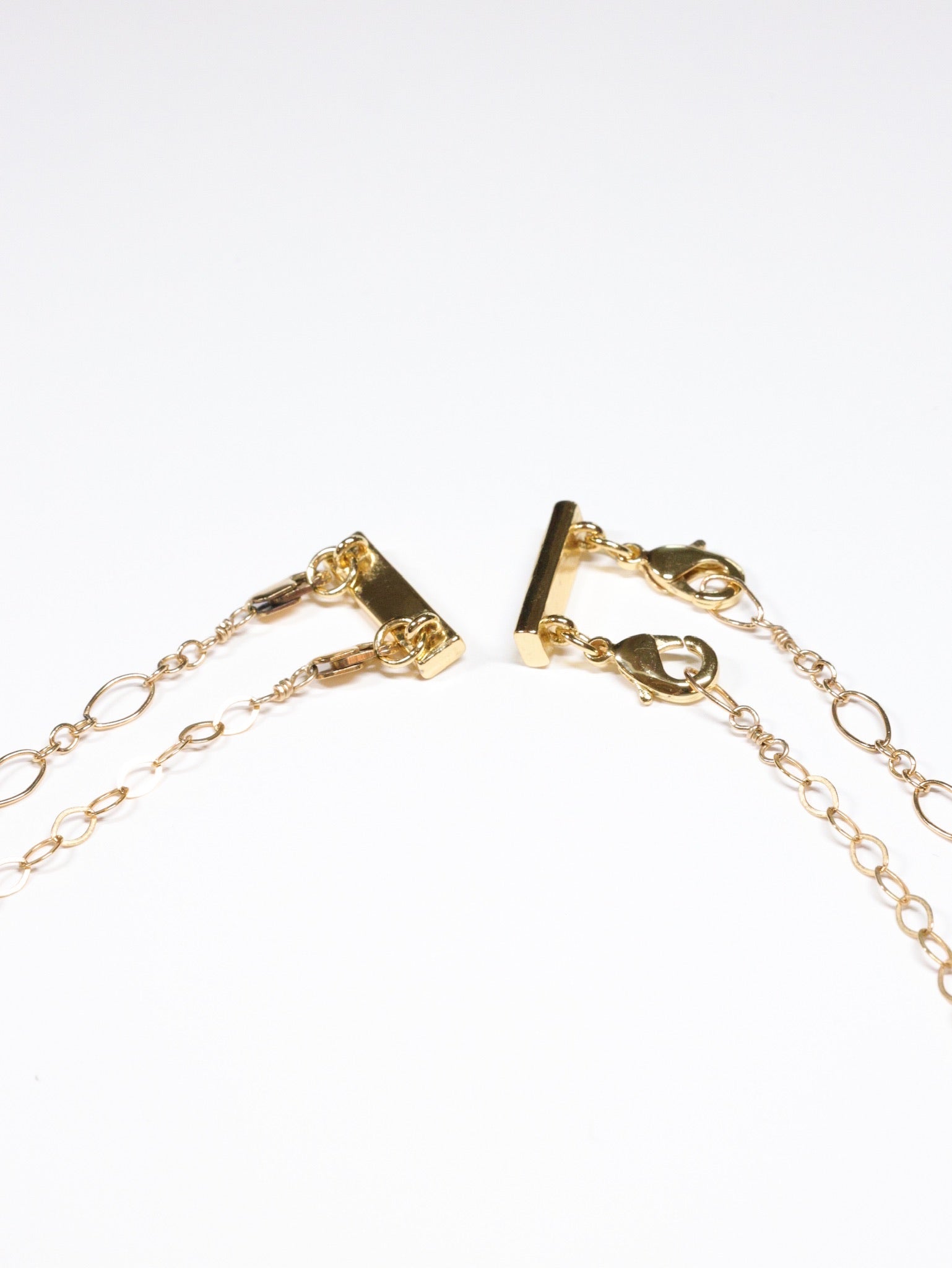 Layering Clasp shown connect to 2 gold necklaces
