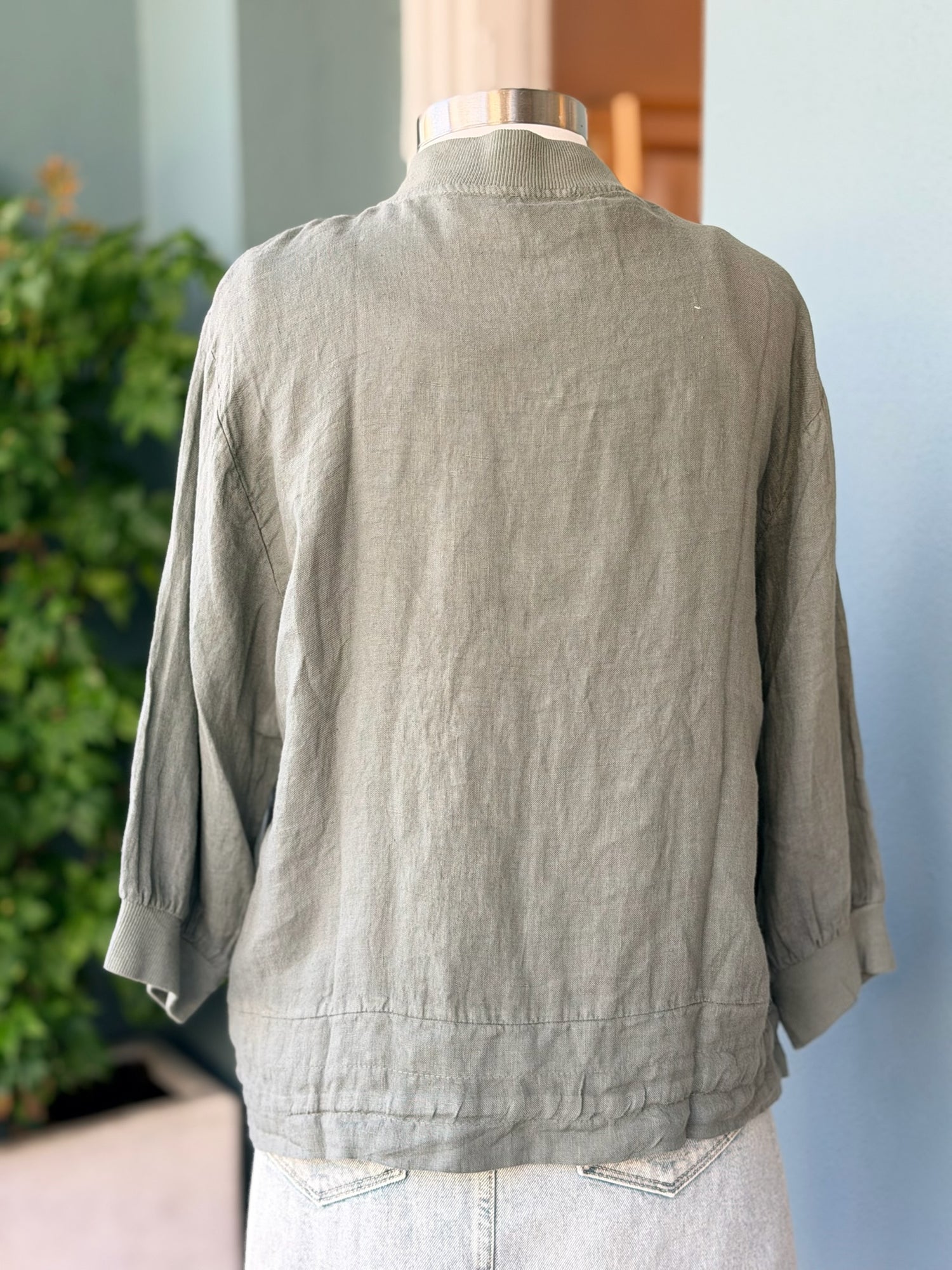 Back view of the Lia Linen Jacket in olive at Ardor Boutique. Made in Italy showing relaxed linen drape three quarter sleeves and gathered drawstring hem