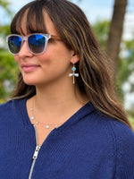 Lila Dragonfly Earrings in Silver displayed on a white background, featuring turquoise-blue faceted stones, deep blue accents, textured silver dragonflies, and fishhook closures.