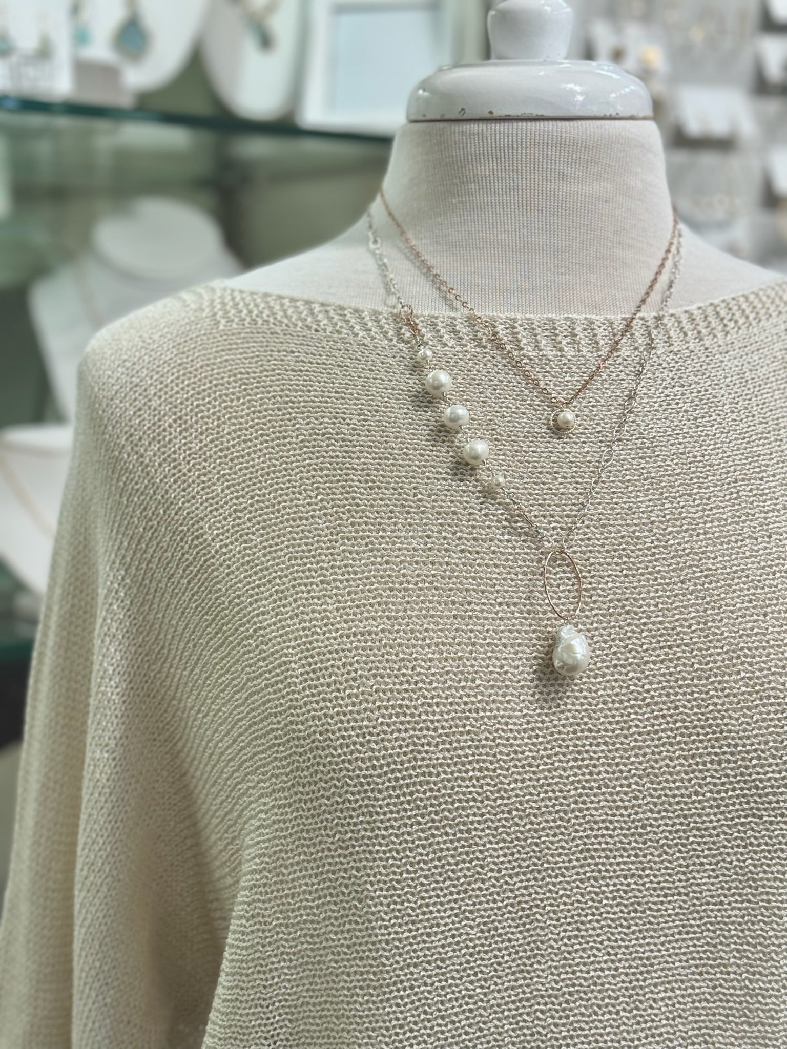 Close-up of sheer textured knit sweater with a boat neckline.