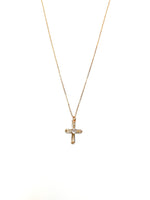Gold cross necklace on a white background