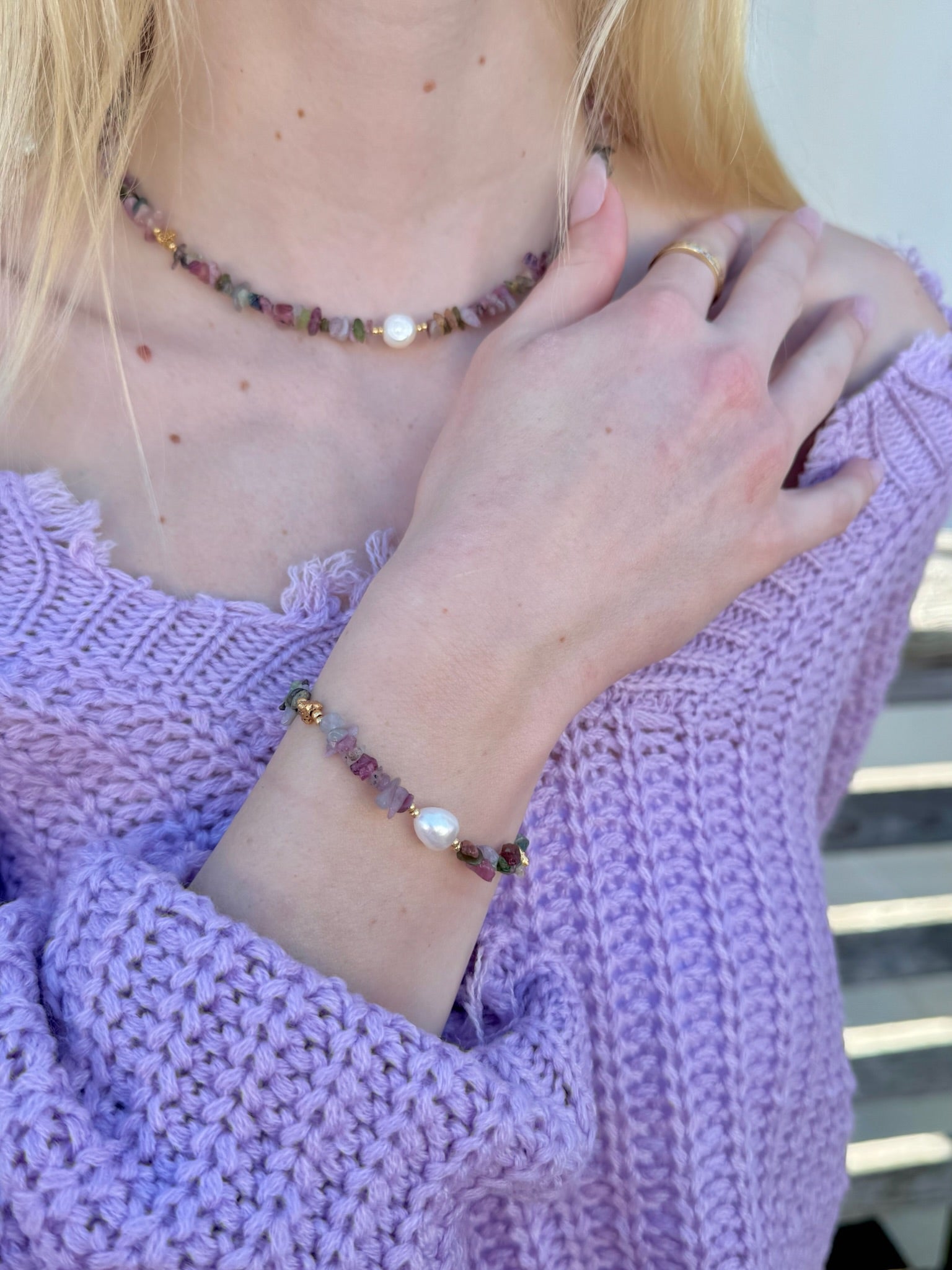 Mira Tourmaline & Pearl Necklace and matching bracelet styled with a purple sweater on model