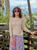 Model wearing Briella gold shimmer sweater with relaxed dolman sleeves and metallic knit