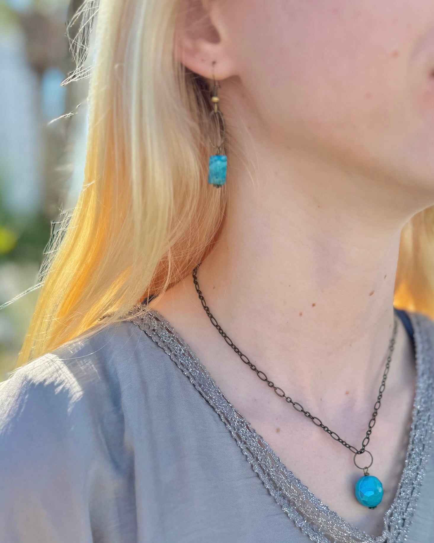 Model wearing Ocean Jasper natural brass dangle earrings by Nina Halls