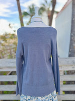 Dark grey knit sweater with blue beaded necklace back view