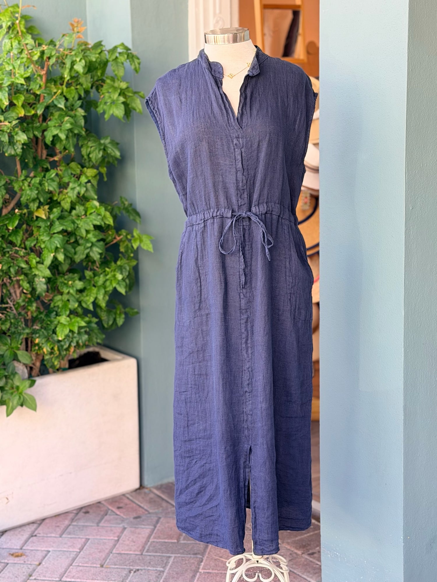 Navy sleeveless linen midi dress with tie waist displayed on mannequin