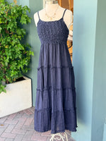 Navy tiered sleeveless dress with textured bodice and spaghetti straps displayed on mannequin