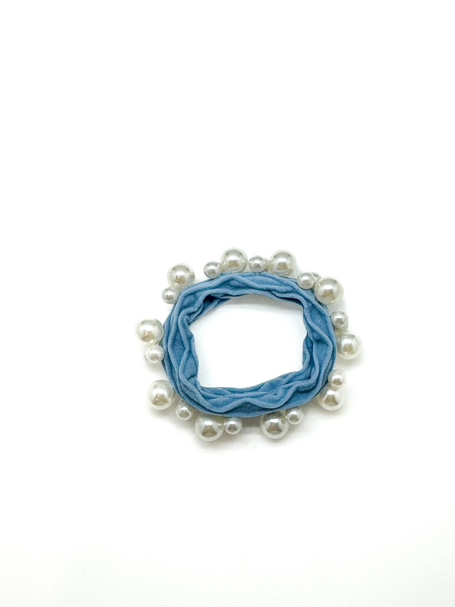 Blue scrunchie with white pearls on a white background