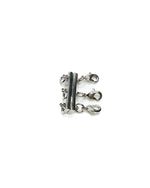 Silver magnetic triple layering clasp on a white background 