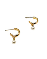 A pair of gold hoop earrings with a small white pearl dangle, shown on a plain white background.