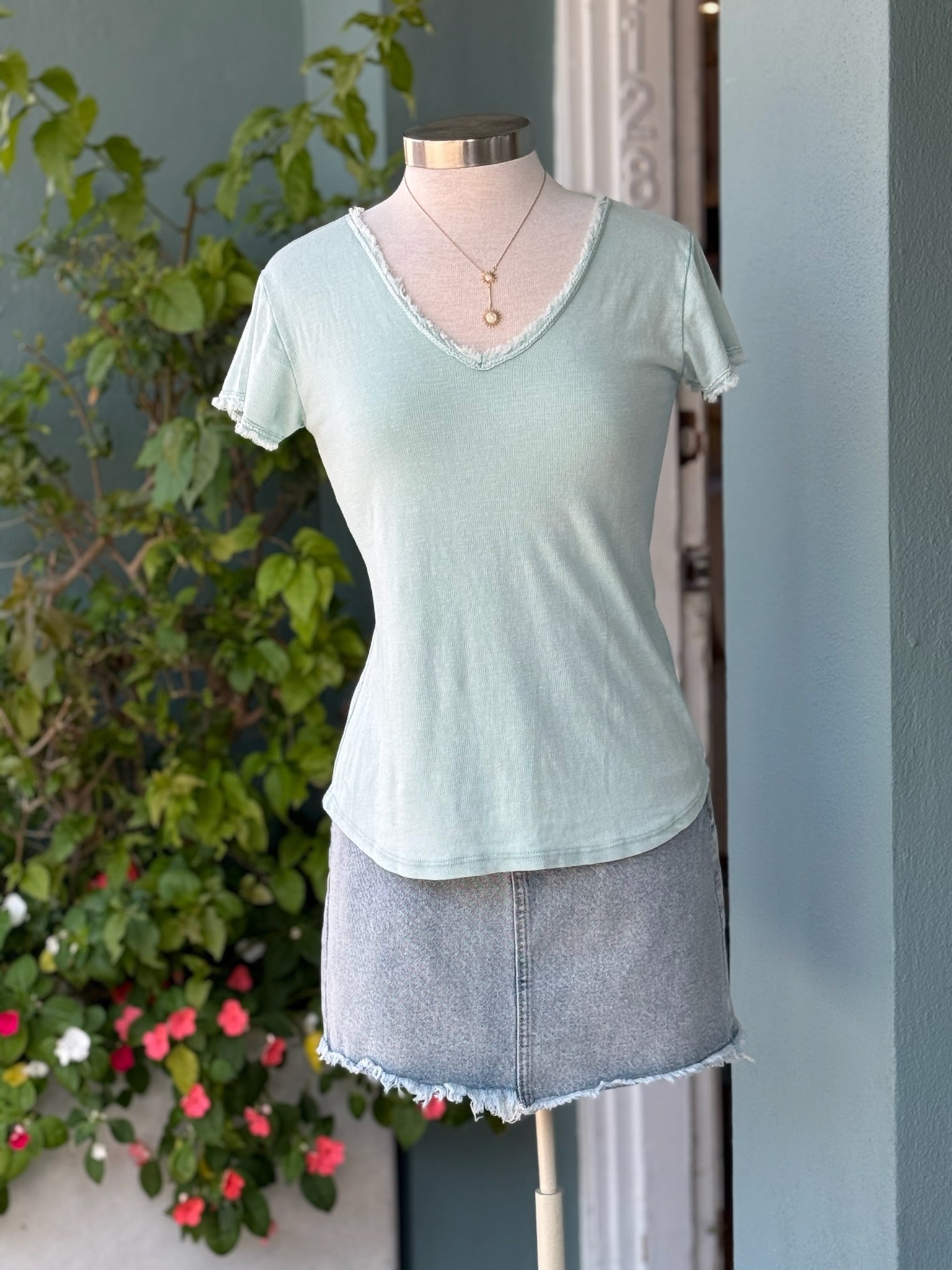 Reece Tee in sea foam on mannequin styled with a light wash denim skirt