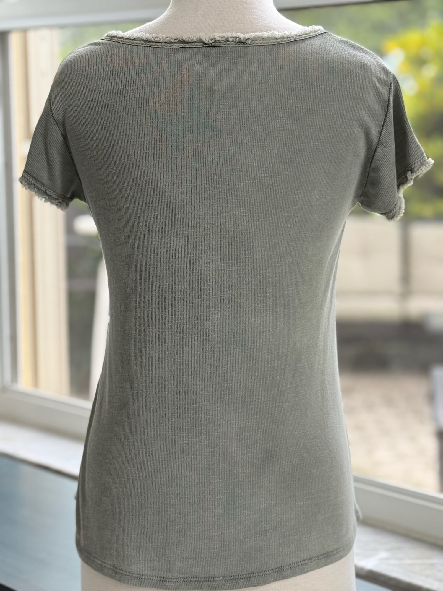 Reece Raw Edge Top in olive (back view of mannequin)