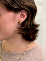 Gold rose studs being worn