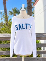 White lightweight knit SALTY sweater with blue lettering, wide boat neckline, relaxed fit, and long sleeves, photographed at Ardor Boutique.