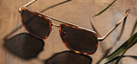 Grant Matte Brindle & Gold /Walnut Grey Polarized Sunglasses styled against wood paneling