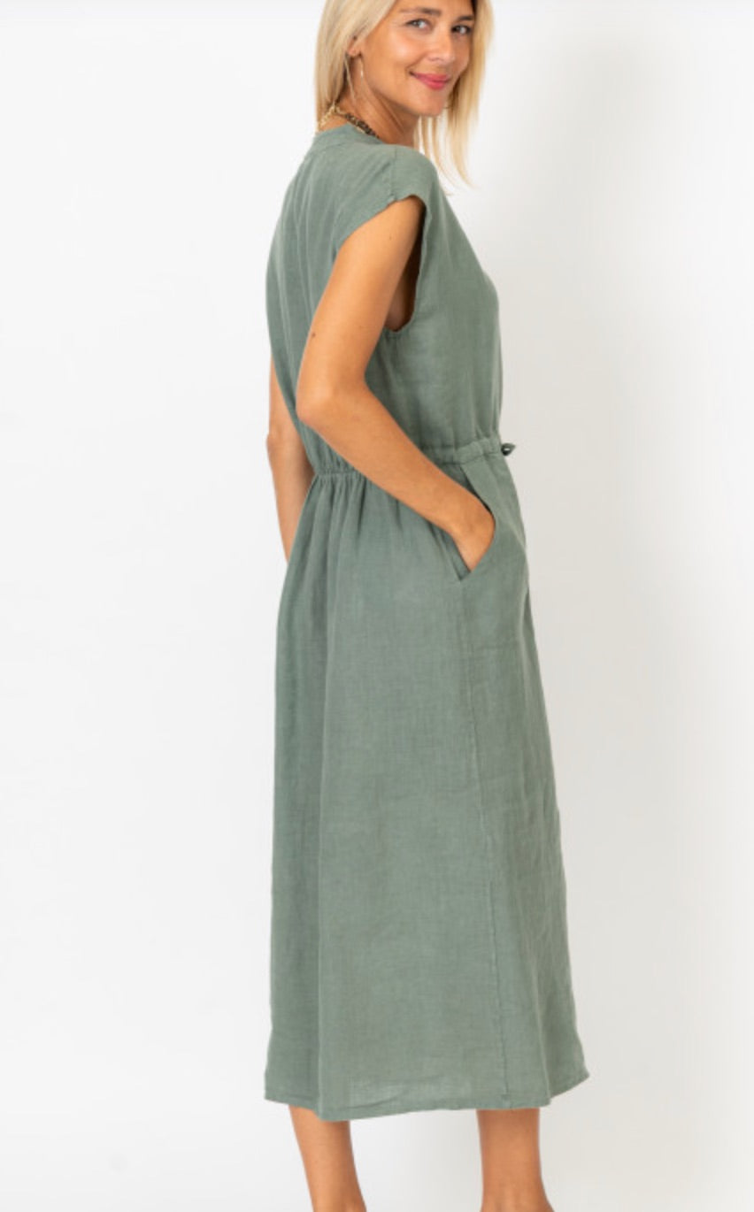 Sharon Olive Linen Dress on model showing the angled view of back and side of the dress. cinch waistline