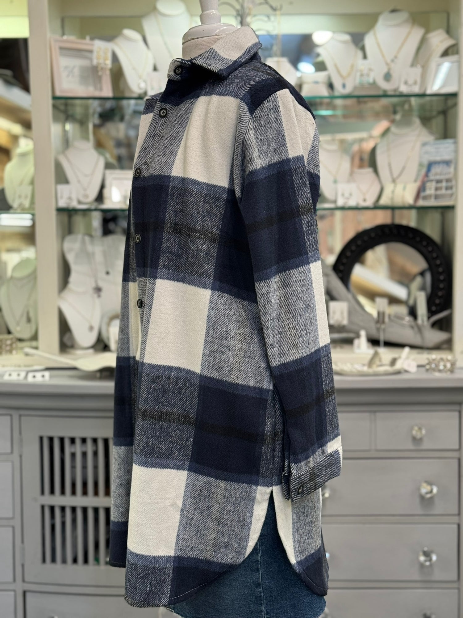 Side view of navy plaid shacket for women with longline silhouette.