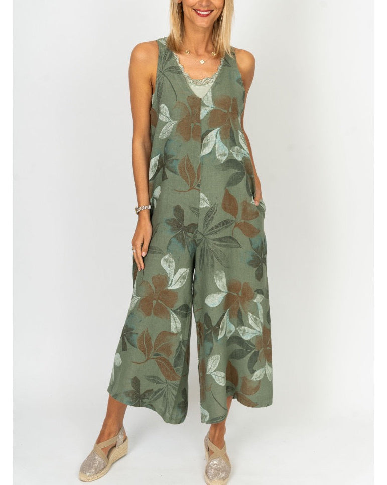 Model wearing the Sienna Leaf Print Romper in Olive with wide legs and floral print