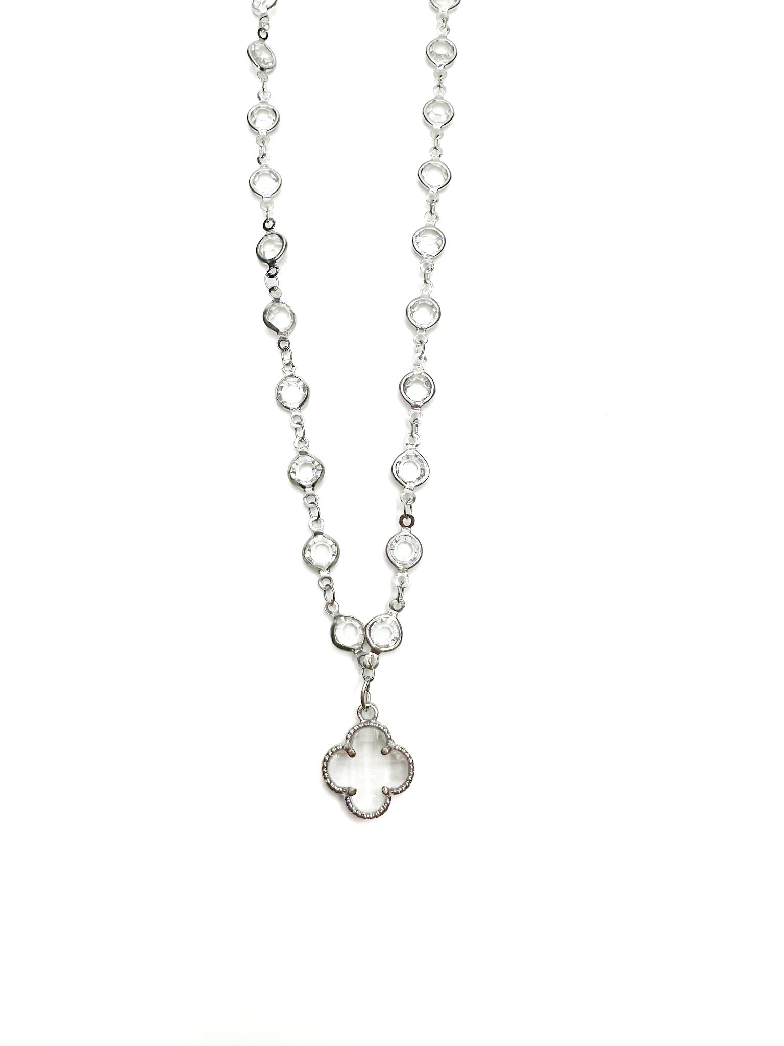 Silver necklace with a clover pendant on a white background