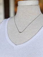 Stacey Necklace in silver styled with a white tank, showing its delicate three-crystal design and subtle sparkle at Ardor Boutique.