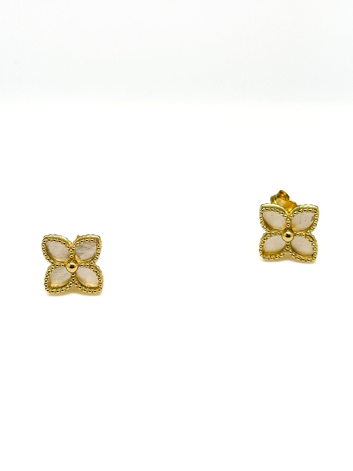 Mother of pearl clover floral stud earrings on a white background