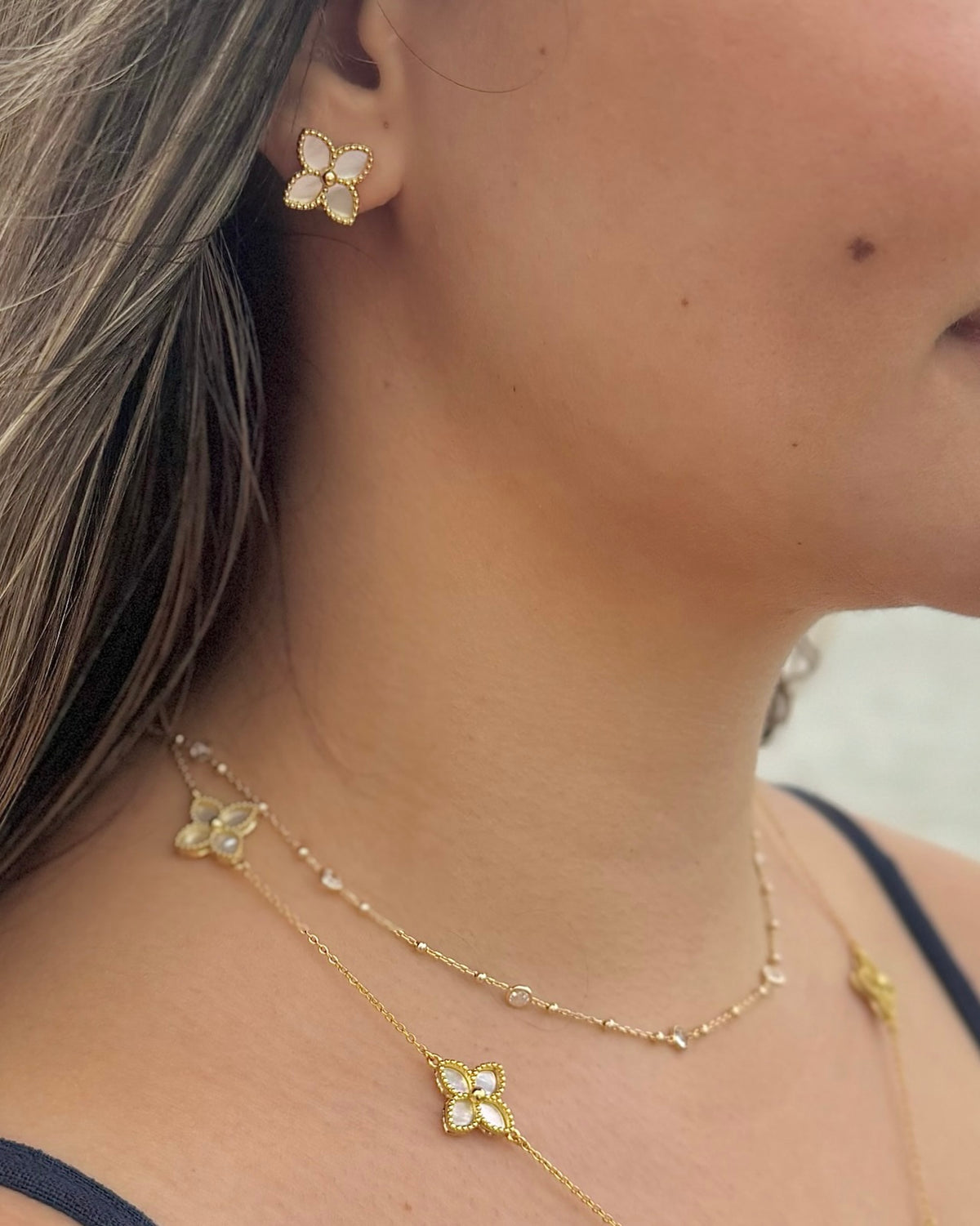 Sylvia mother of pearl earrings styled with coordinating jewelry at Ardor Boutique