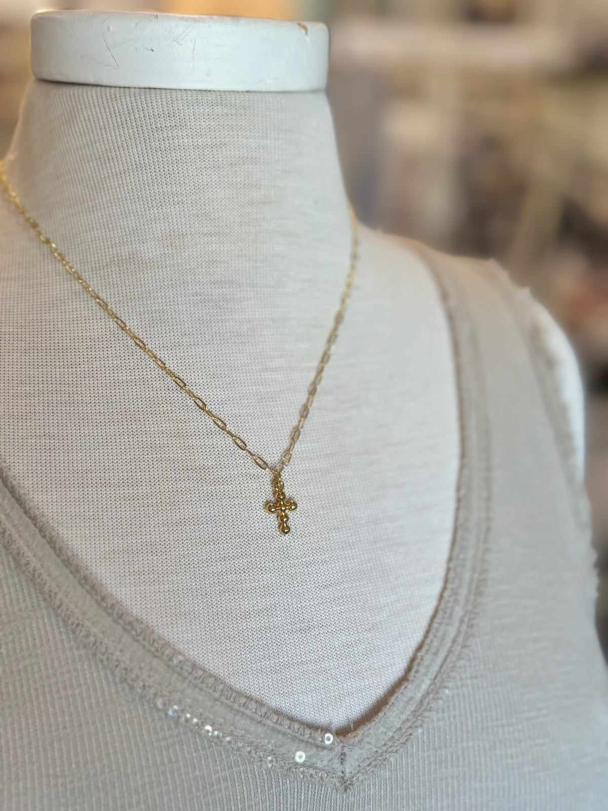 Talia Gold Cross Necklace on mannequin