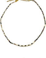 Necklace with multicolored beads on a white background