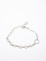 A sterling silver bracelet with moonstone beads and a lobster clasp, displayed against a white background.