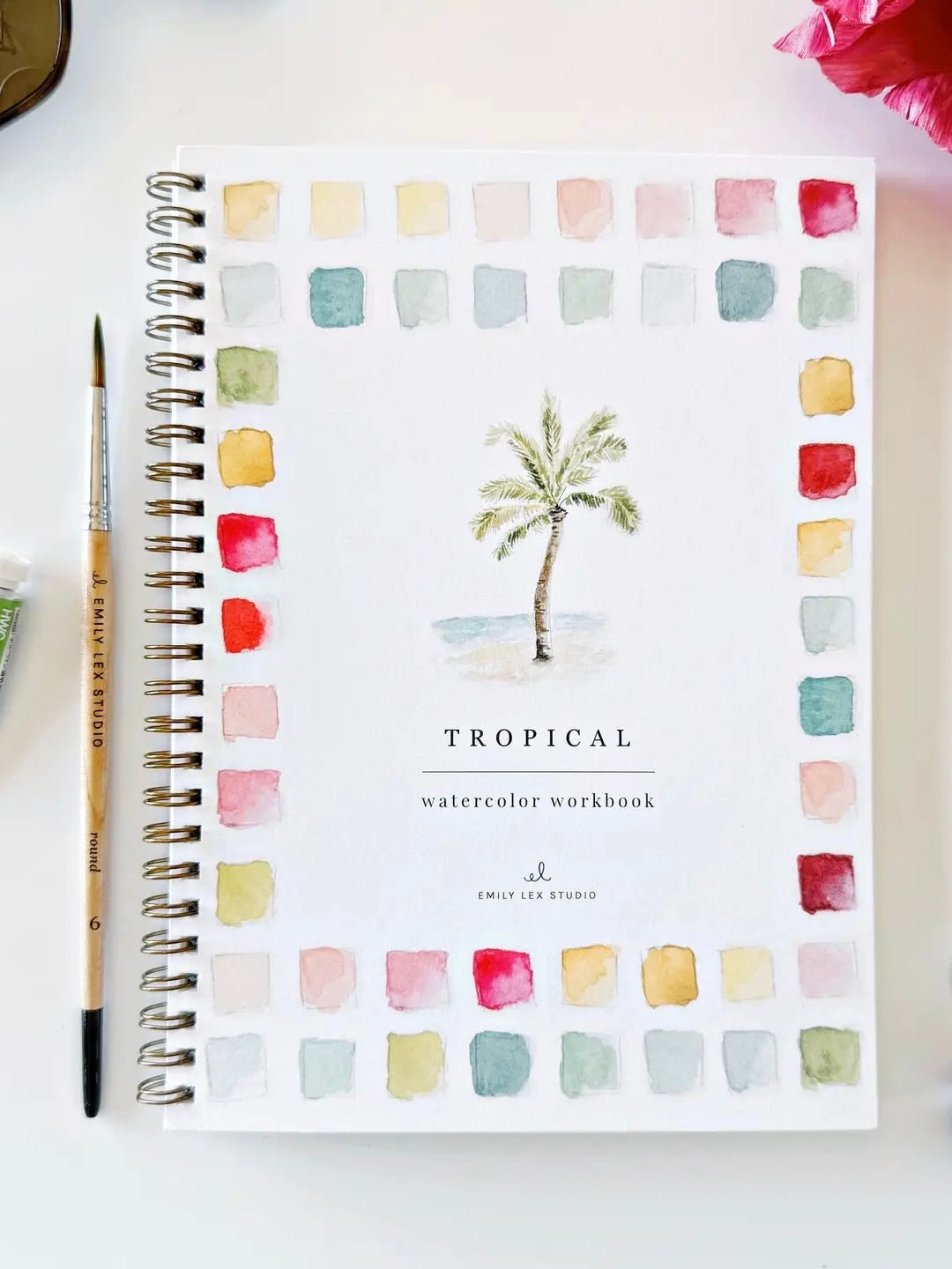 Tropical watercolor workbook front cover with a palm tree illustration and color swatches on a white background.