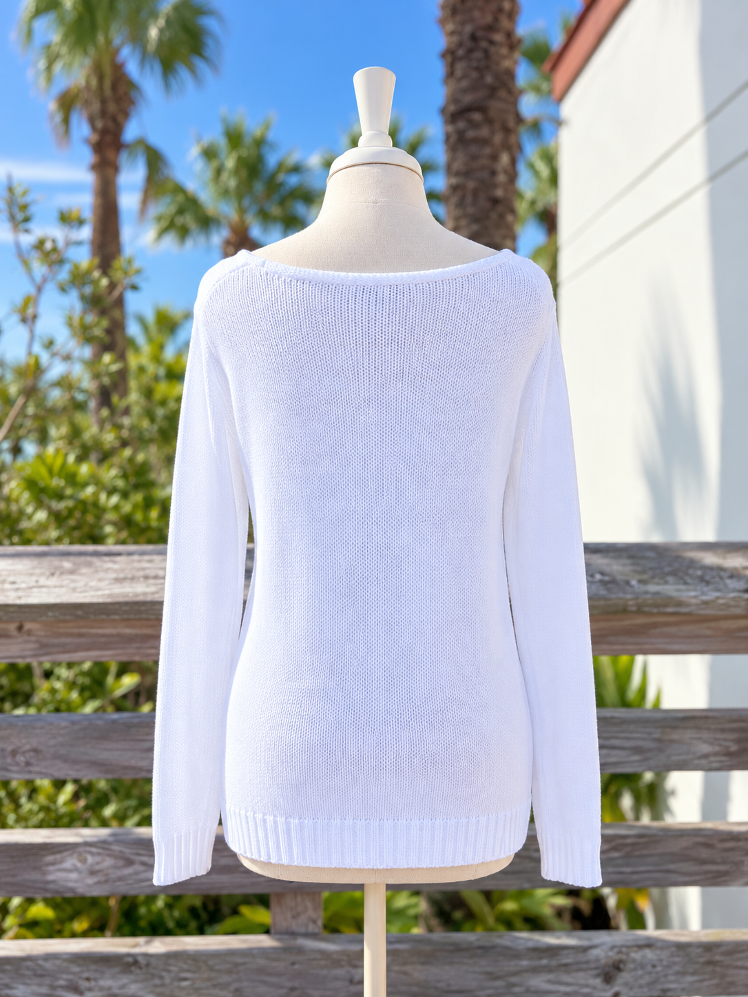 Back view of the white lightweight knit SALTY sweater showing the wide boat neckline, long sleeves, and ribbed hem at Ardor Boutique.