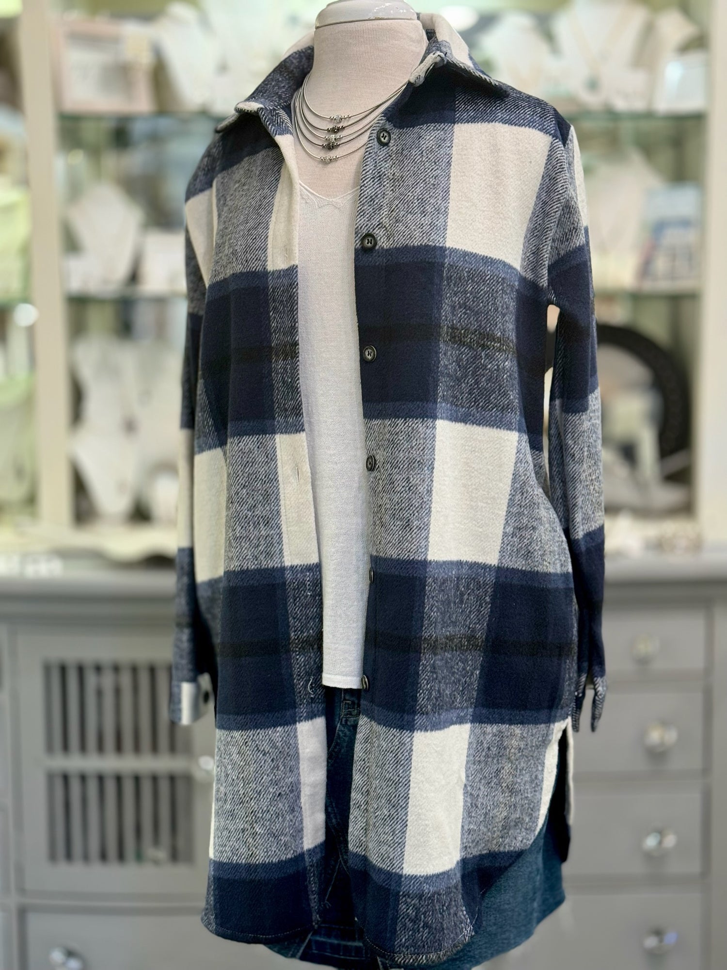 Women’s navy plaid button-down shacket with relaxed fit and pockets.