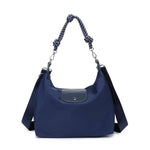 A navy blue nylon shoulder bag with a dark gray leather front flap, a knotted rope handle, and a detachable shoulder strap, shown on a plain white background.