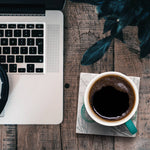Laptop and coffee cup on a seahorse coaster, Ardor boutique