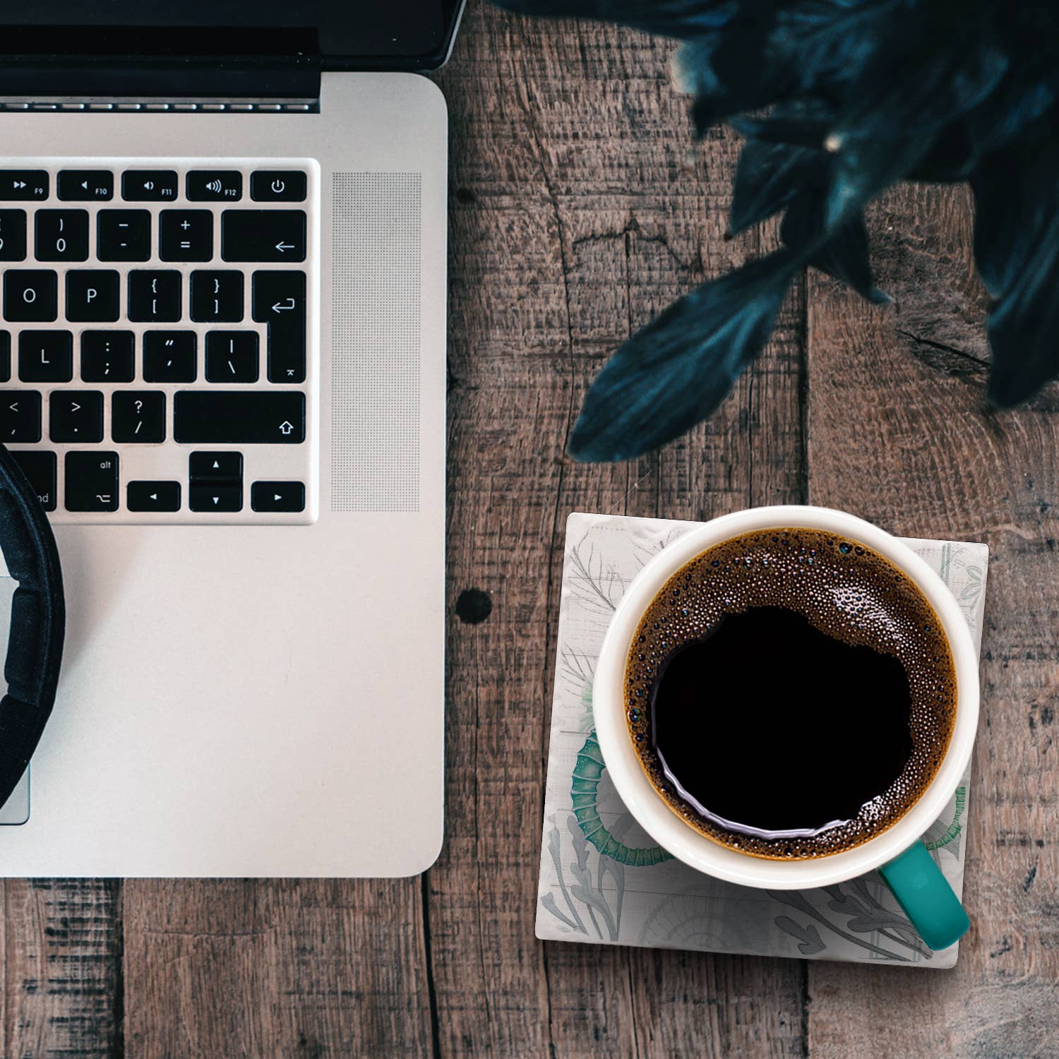 Laptop and coffee cup on a seahorse coaster, Ardor boutique