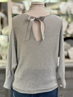 Back view of Briella silver grey shimmer sweater with ribbon bow and silver metallic thread