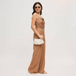 Model wearing the Opalite Evening Bag as a crossbody with a removable gold-tone chain strap, showcasing its shimmering opalescent shell disc embellishments.
