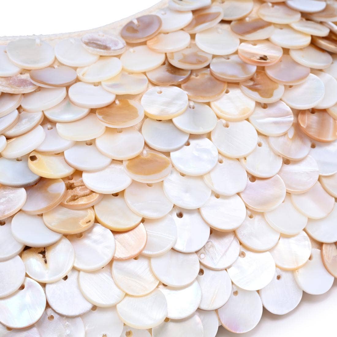 Close-up of layered iridescent shell disc embellishments showcasing the shimmering texture and natural pearlescent finish of the Opalite evening bag. 