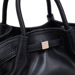 Close-up of the Selena Crossbody highlighting the soft gathered vegan leather, rolled top handles, refined stitching, and polished gold-tone hardware.