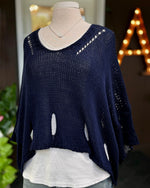 Front view of the Eleni navy cropped sweater layered over a white tank and light-wash jeans on a mannequin.