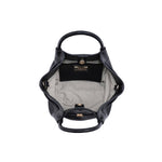 Interior of the Selena Crossbody featuring a herringbone fabric lining, spacious main compartment, interior slip pocket, and magnetic snap closure.