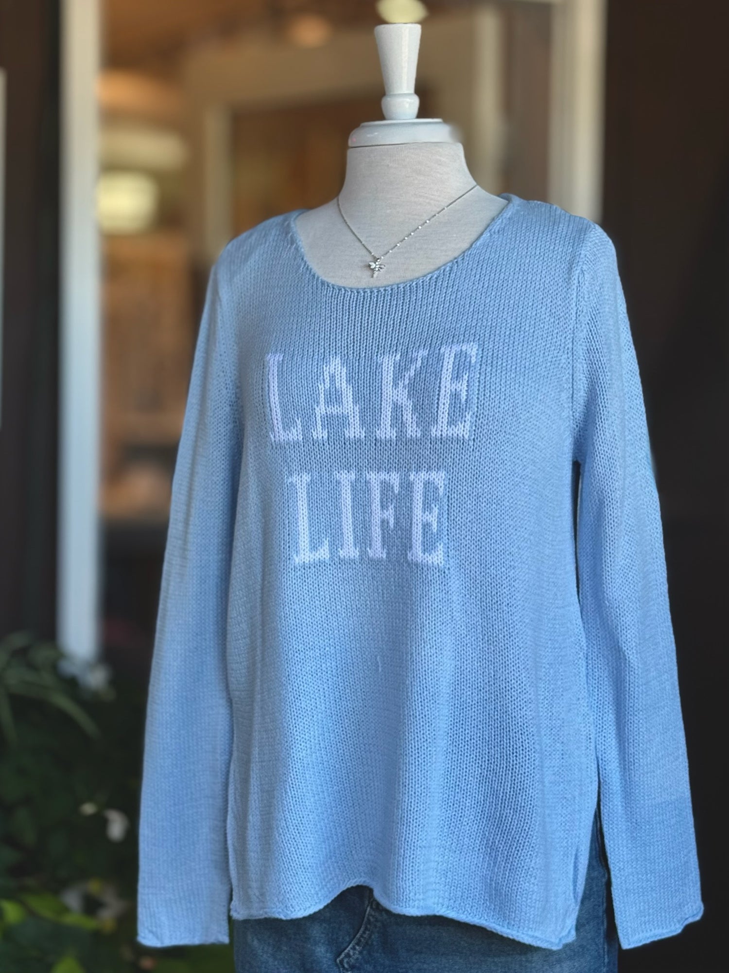 Cotton acrylic sky blue Lake Life sweater with ivory lettering, front view on mannequin from Ardor Boutique
