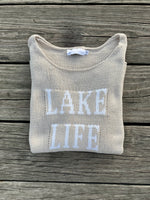 Cotton acrylic tan Lake Life sweater folded on wooden dock from Ardor Boutique