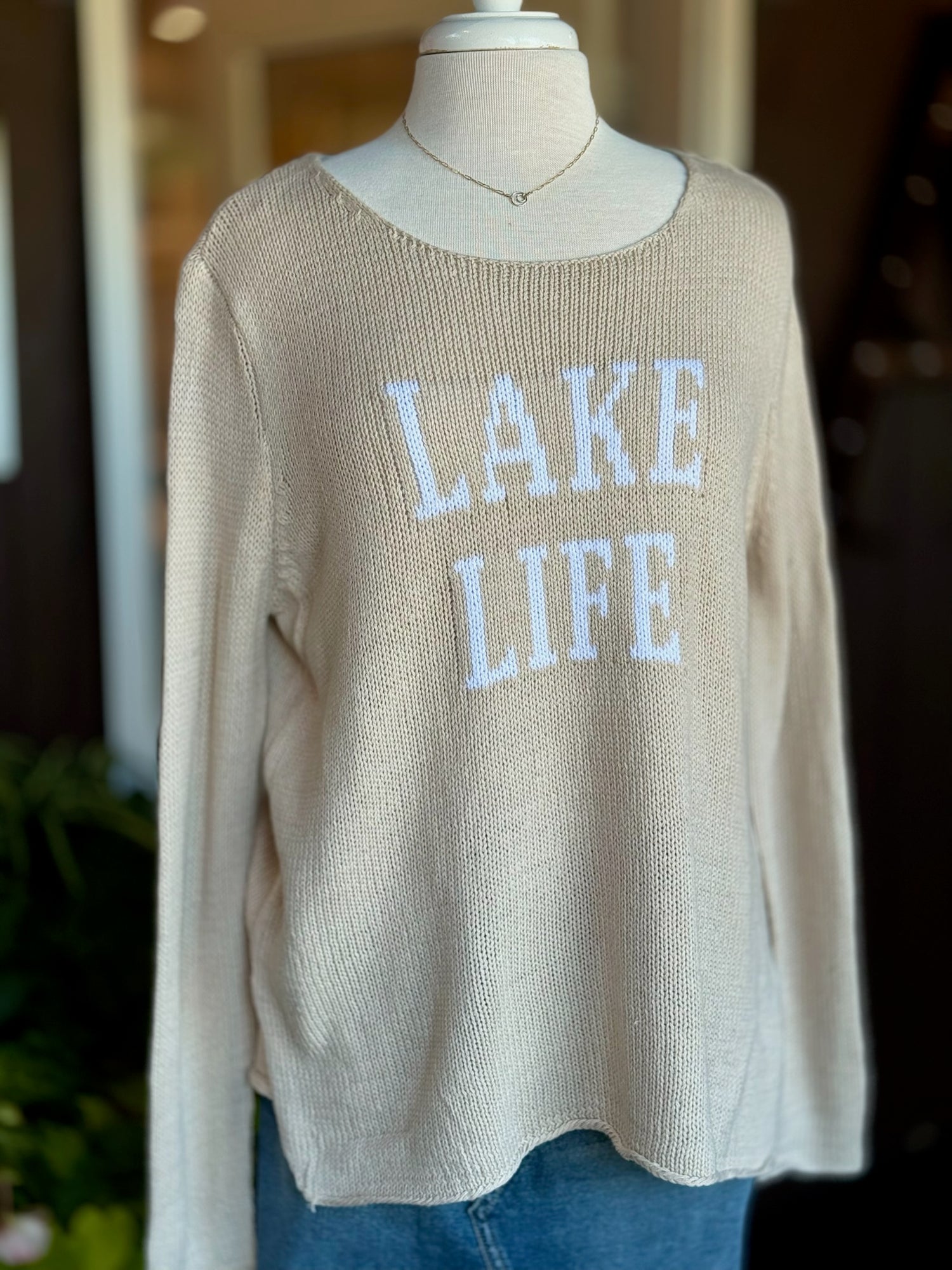 Cotton acrylic tan Lake Life sweater with ivory lettering, front view on mannequin from Ardor Boutique