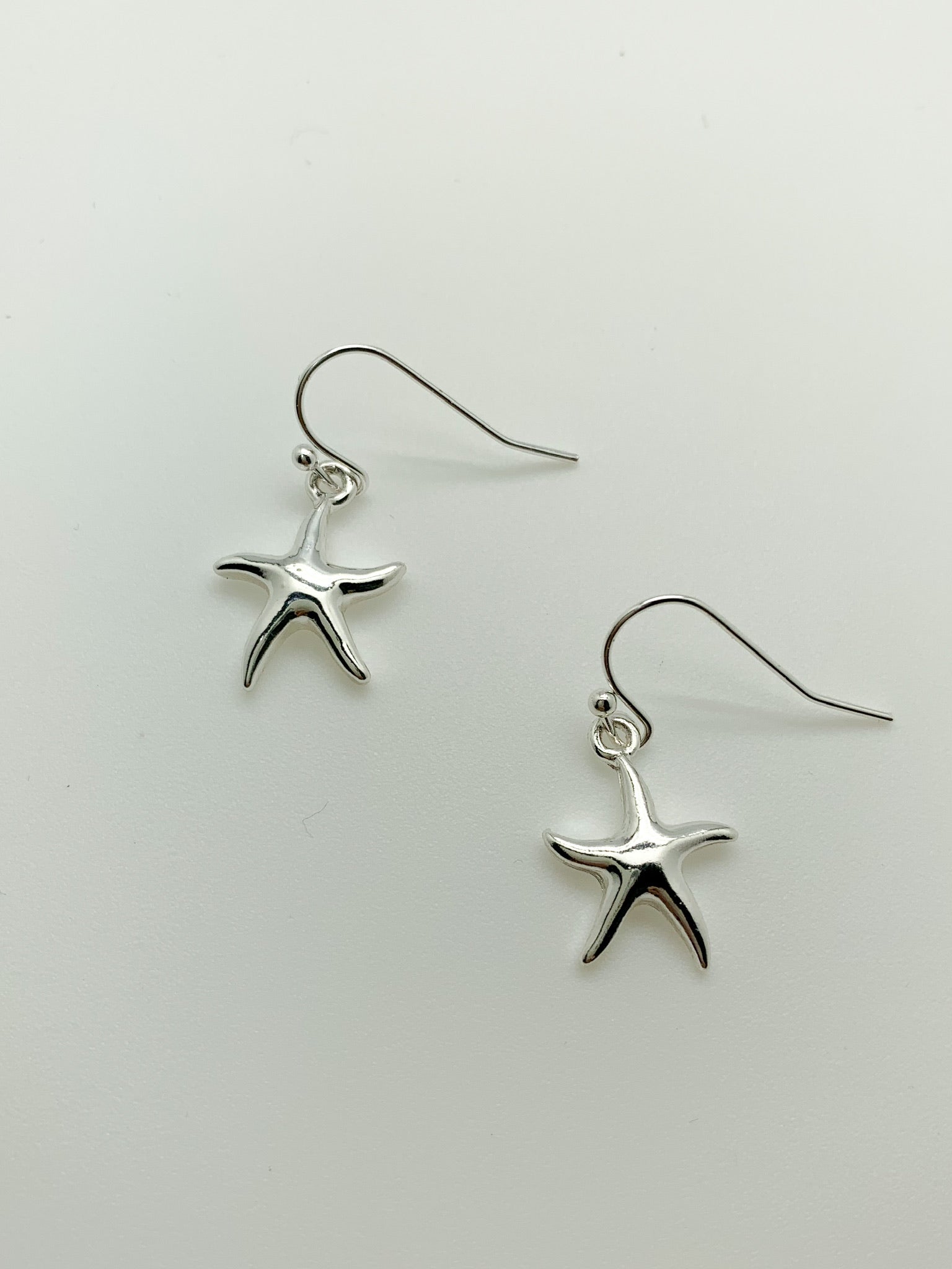 Small Dangly Starfish earrings in silver. Layne.